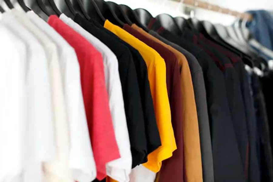 Colourful shirts hanging on a clothing rail