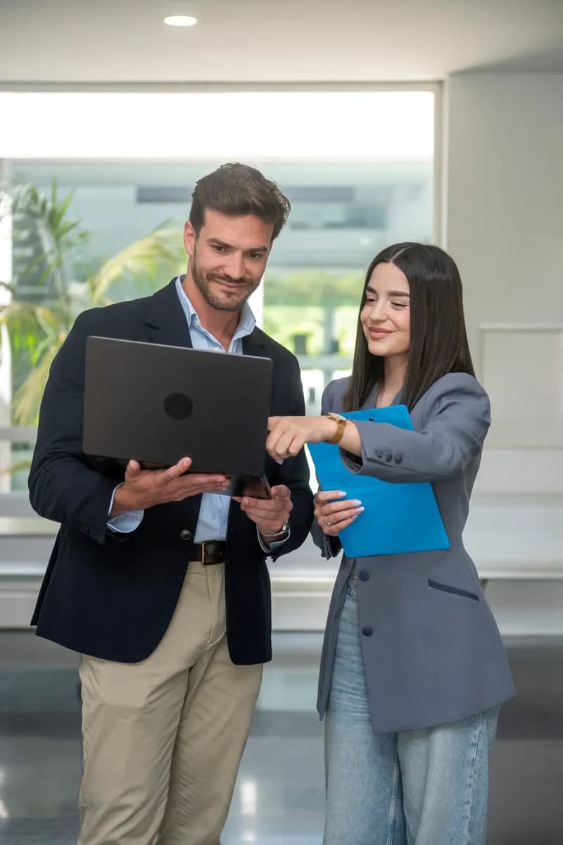 Business professionals discussing surplus buyers over a laptop